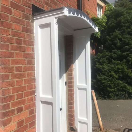 White door canopy on brick wall