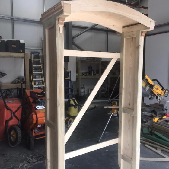 Wooden frame under construction in workshop.