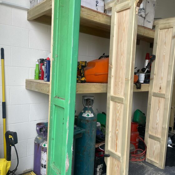 Workshop shelves with tools and wooden panels