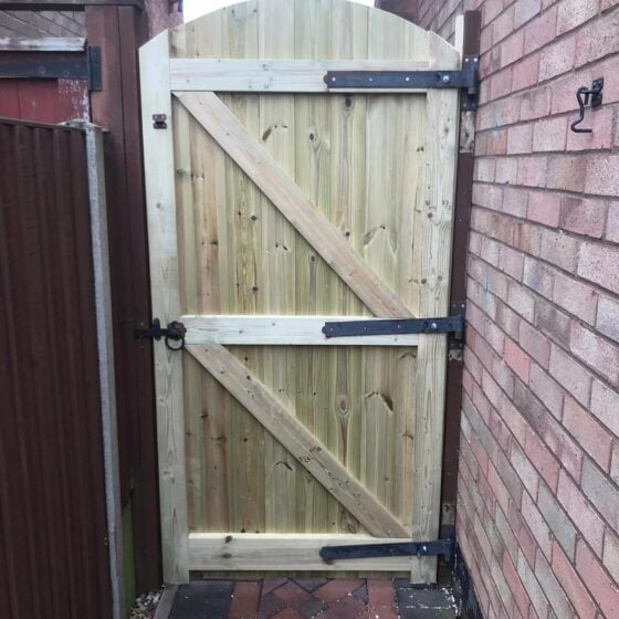 New wooden garden gate between fences