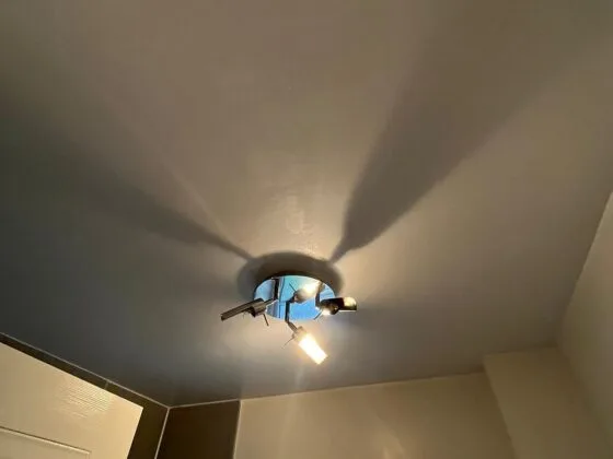 Ceiling light fixture in a room corner.