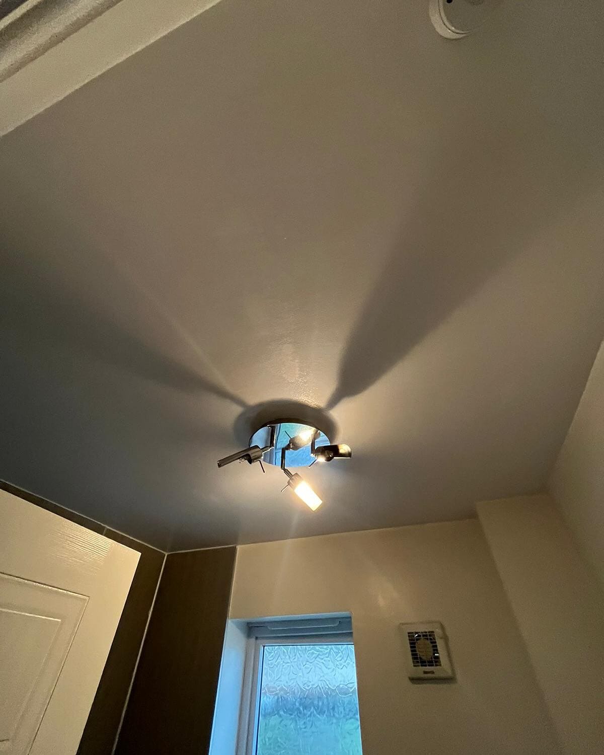 Ceiling light fixture in a room corner.